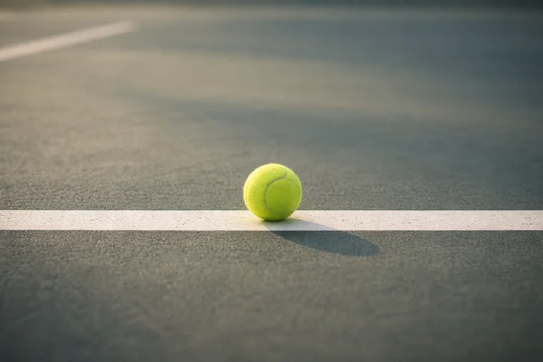 Tennis ball on court baseline